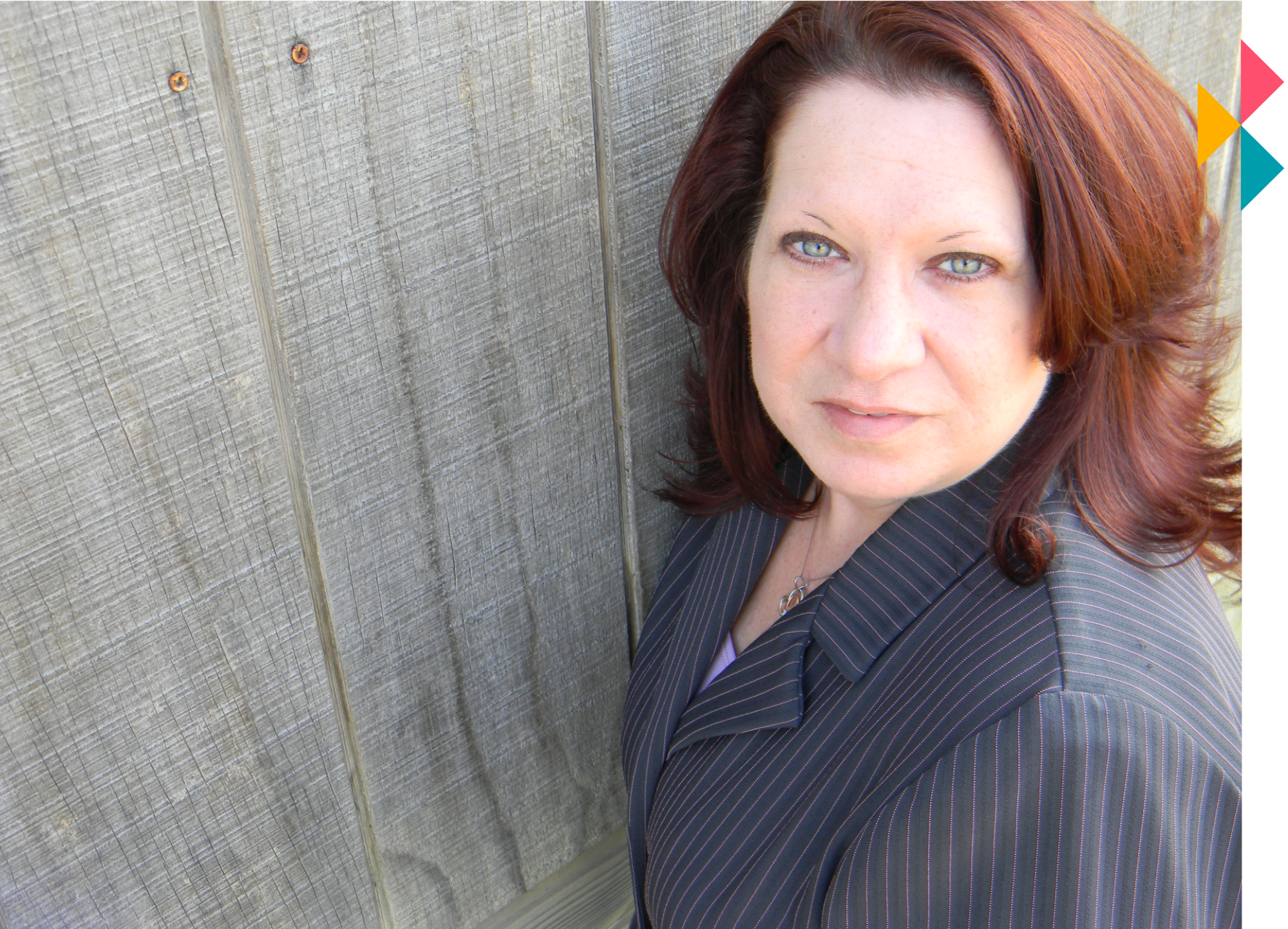 keri standing in front of wooden barn